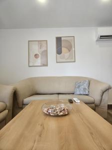 a living room with a table and a couch at Apartments Tea and Tamara in Pirovac