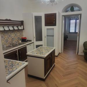 a kitchen with a sink and a counter top at Casa Di Bella Taormina in Roccalumera