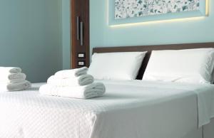 Postel nebo postele na pokoji v ubytování B&B Riviera Azzurra