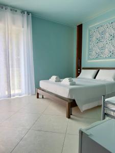 Postel nebo postele na pokoji v ubytování B&B Riviera Azzurra