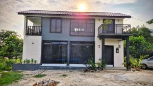 a house with a lot of windows at Villa Aisya in Kampung Padang Masirat