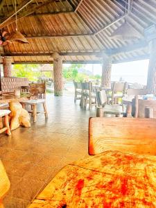 a large room with tables and chairs and a table at Batu Belah Bungalows and Restaurant in Data