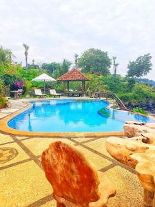 a large swimming pool with a gazebo in a resort at Batu Belah Bungalows and Restaurant in Data