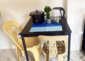 a black table with two chairs and a blender at Centrally located studio 1 with AC and kitchenette in Coron
