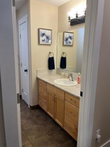 a bathroom with a sink and a mirror at 2 bedroom upper level home in Grande Prairie in Grande Prairie