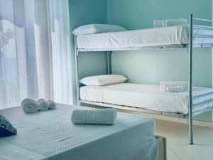 Postel nebo postele na pokoji v ubytování B&B Riviera Azzurra
