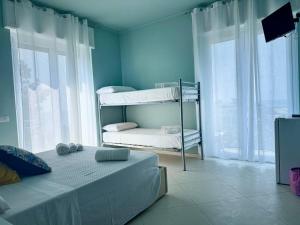 Postel nebo postele na pokoji v ubytování B&B Riviera Azzurra