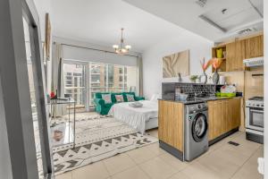 a kitchen and living room with a bed and a stove at Burj Al Nujoom Luxurious Apartment Downtown Dubai Mall in Dubai