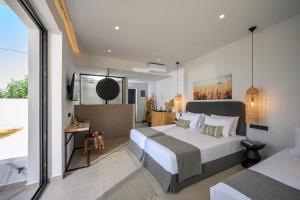 a bedroom with two beds and a large window at Theros Hani Sea in Kokkíni Khánion