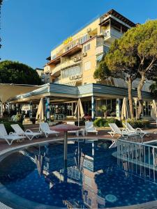 a hotel with a pool in front of a building at Manta Apartment Albania in Golem