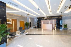 a lobby with chairs and a reception desk in a building at Burj Al Nujoom Luxurious Apartment Downtown Dubai Mall in Dubai +184 photos