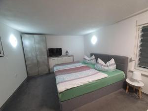 a small bedroom with a bed with a green mattress at Ferienhaus Cziuppa in Bad Salzungen