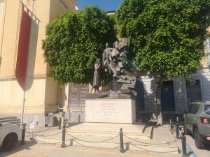 a statue of a woman in front of a building at 17 Domus Mariae Town House in Senglea