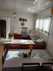 a kitchen with a sink and a counter top at Grace Homestay in Naselesele