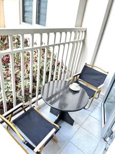 a table and two chairs on a balcony at 40sqm Minimalist Condo w Balcony SM Marilao in Marilao