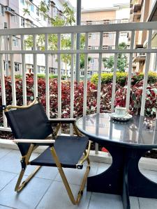 a chair and a table on a balcony at 40sqm Minimalist Condo w Balcony SM Marilao in Marilao