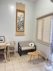 a living room with a couch and a table at 40sqm Minimalist Condo w Balcony SM Marilao in Marilao +5 photos