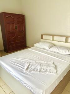 a white bed with a white towel on it at 40sqm Minimalist Condo w Balcony SM Marilao in Marilao
