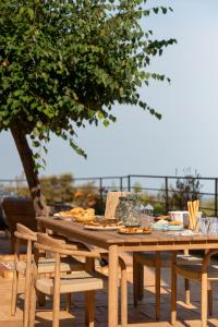 a wooden table and chairs with food on it at Bastide Saint-Honorat in Grasse