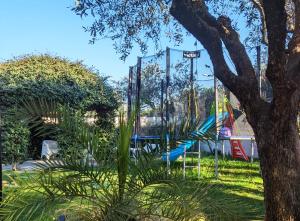 a playground with a slide in a park at Fontana Oasis Apartments in Castelnuovo del Garda