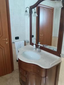 a bathroom with a sink and a mirror at Locazione turistica Casa Peppe in Manduria +21 photos