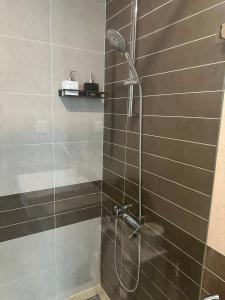 a shower with a shower head in a bathroom at Soho Apartment Central in District 1 in Ho Chi Minh City +34 photos