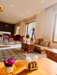 a living room with a couch and a table at Hotel Lungpa Valley in Leh +13 photos