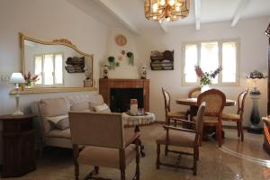 a living room with a couch and a table and a mirror at Cottage-Casolare pugliese in San Vito dei Normanni