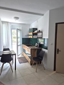 a kitchen with a table and chairs in a room at YES Varna Studios in Varna City