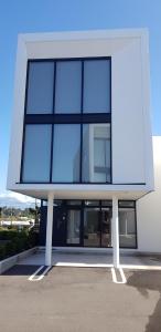 a building with a large window on the side of it at Mountain View Townhouse, New Plymouth in New Plymouth