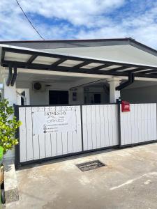 a white fence in front of a house at Teratak Orked in Pekan