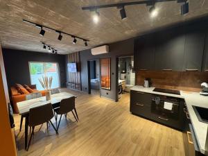 a kitchen and living room with a table and a couch at Apartament Baltic 13 Mielno in Mielno