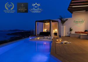 a villa with a swimming pool at night at Emerald Villas & Suites - The Finest Hotels Of The World in Agios Nikolaos