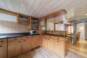 a kitchen with wooden cabinets and a dining room at Le studio in Turckheim