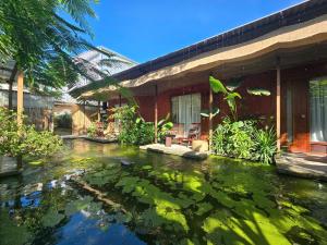 a large koi pond in front of a house at CasaWa Homestay Hue in Thôn Trường Giang