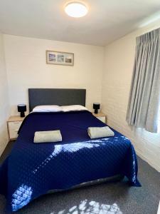 Postel nebo postele na pokoji v ubytování Sails Motel Geraldton