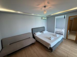 a small bedroom with a bed and a couch at Hotel Parthenon Rodos city in Rhodes Town