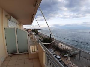 a balcony with a view of the ocean at Akrata Beach Quality Furnished Apartments in Paralía Akrátas
