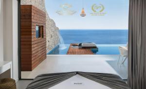 a room with a view of the ocean at Emerald Villas & Suites - The Finest Hotels Of The World in Agios Nikolaos