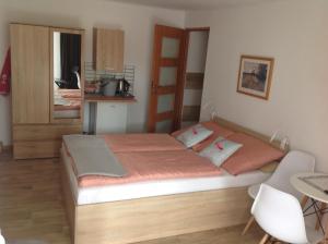 a bedroom with a bed and a table and a kitchen at Bowal in Grzybowo