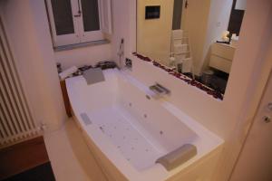 a bath tub in a bathroom with a mirror at B&B Massimo Inn in Palermo