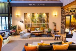 a lobby of a hotel with couches and chairs at Nine Valley Park in Boeun
