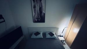 a bedroom with a bed with two pillows on it at Sibejdo 1&2 in Varaždin