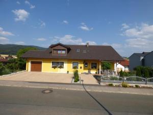 a yellow house with a brown roof at Ferienwohnung Simon In Gleißenberg in Gleißenberg