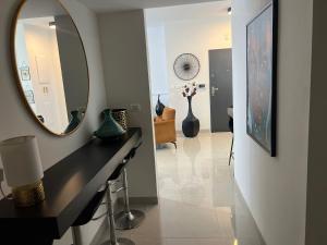 a hallway with a mirror and a table and vases at Kineret sheli- 4Bedrooms luxury apartment with stunning lake view in Tiberias