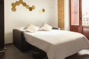 Un pat sau paturi într-o cameră la Soho Valencia