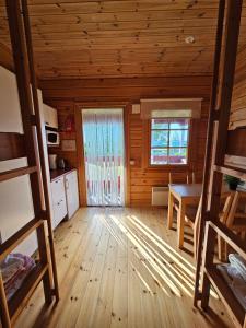 a room with a table and a window in a cabin at Pohjanranta Cottages in Keminmaa
