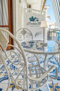 a white table and chairs on a balcony at L'Orchidea Blu in Pianillo