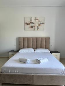 a bedroom with a bed with two towels on it at Vila Ervin Double Room in Ksamil