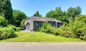 a small stone house with a garden in front of it at Maison Aunais in Mormont-La-Grande